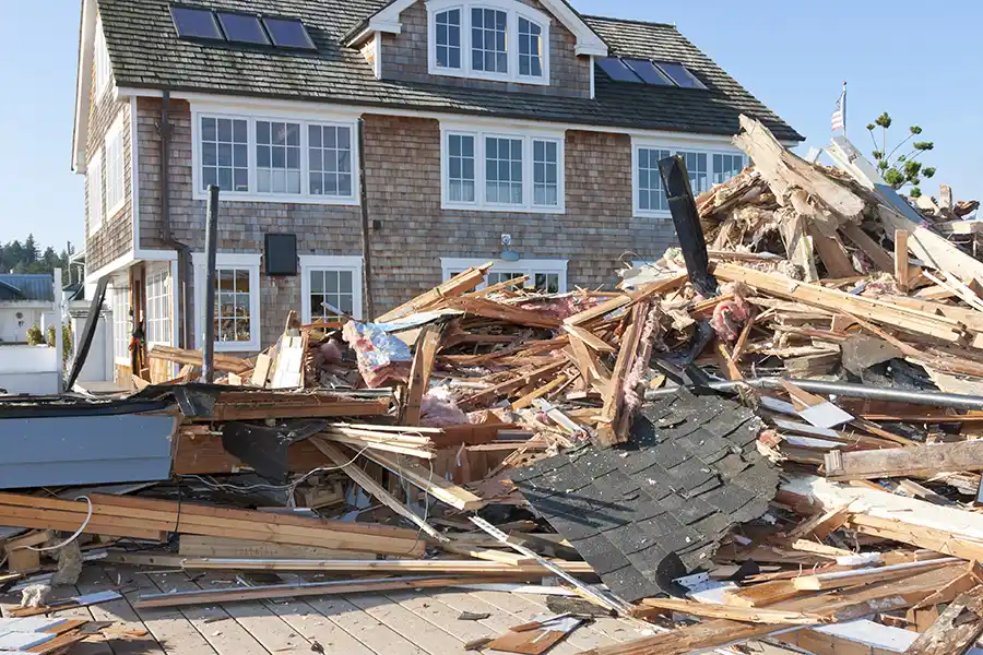 Large pile of construction debris and waste materials staged in front of a residential home under renovation in New Albany, Ohio.